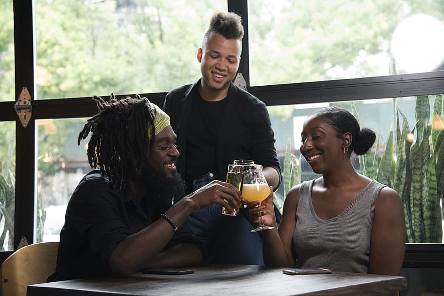 Three Persons Cheers With Clear Glasses Filled With Liquid Beverages Near Window HD wallpaper