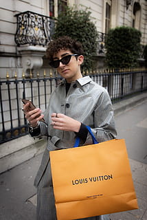 Carrying his louis vuitton travel bag hi-res stock photography and