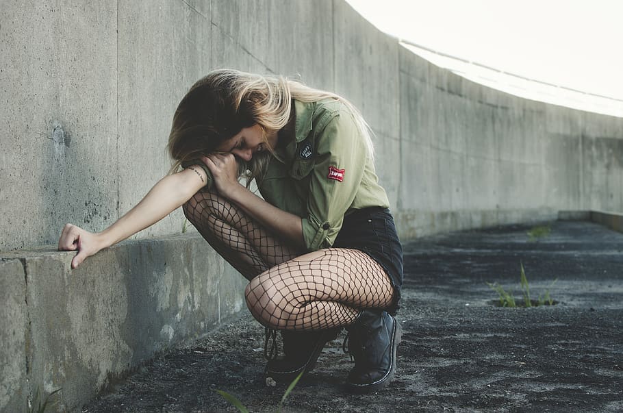 Woman Squatting Near Gray Concrete Wall at Daytime, adorable