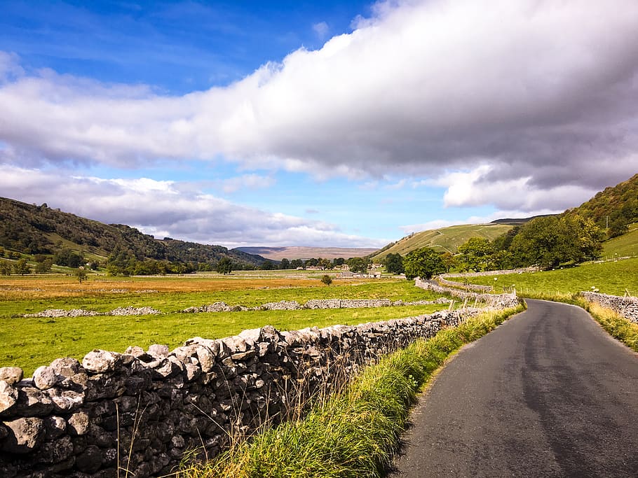 empty road in between green fields at daytime, cloud - sky, scenics - nature HD wallpaper