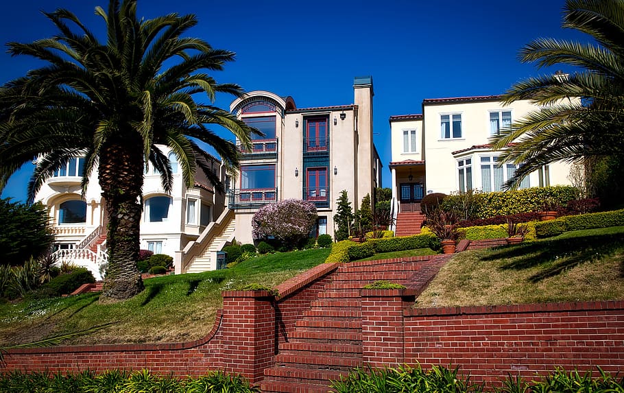 White and Brown Concrete Building Near Green Grass Under Blue Sky during Daytime HD wallpaper