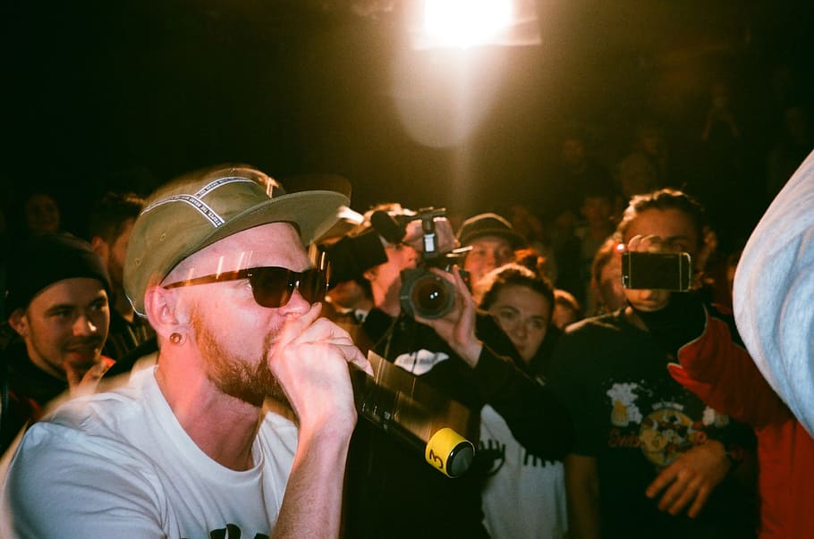 Man Speaking on Microphone Surrounded by People Taking Photo HD wallpaper