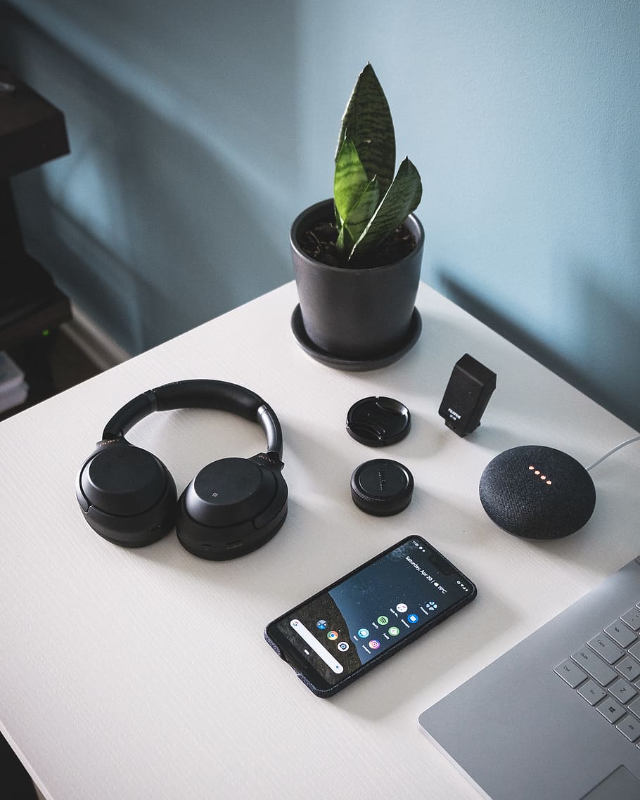 smartphone beside headphones and Google Home Mini, table, wireless technology HD wallpaper