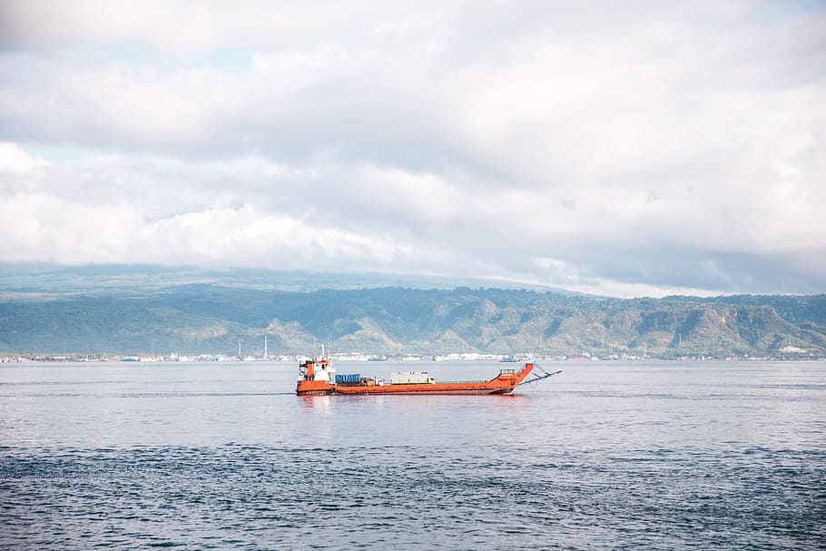 Transport by a carrier boat on a body of water in Indonesia, cloud HD wallpaper