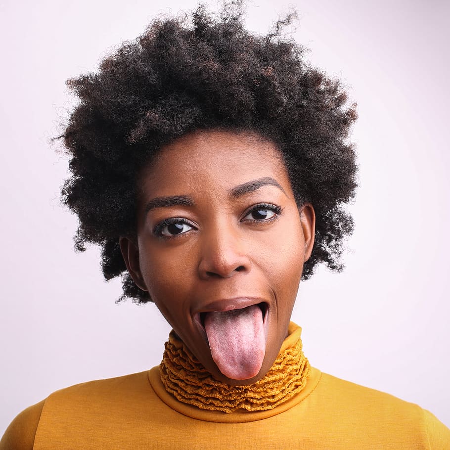 Close-Up Photography of Woman Showing Her Tongue, afro, beautiful