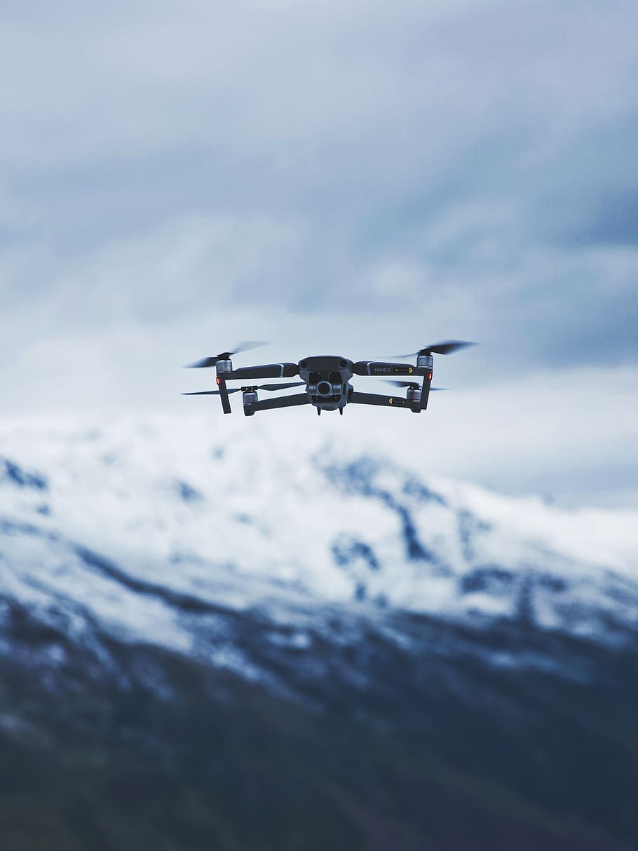gray quadcopter drone under cloudy sky during daytime, flying HD wallpaper