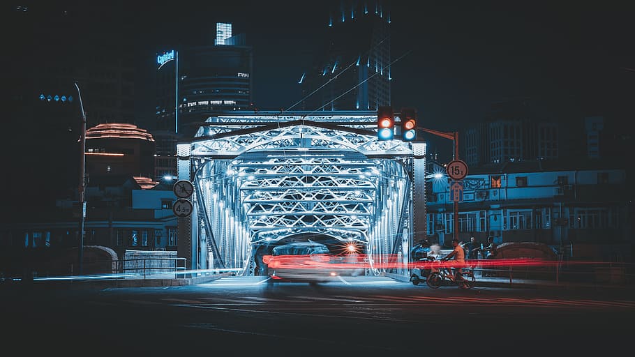 time-lapse photography of vehicle on bridge at nighttime, light