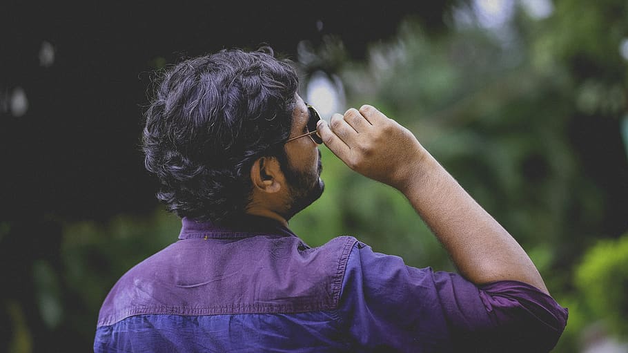 Man Wearing Blue and Purple Dress Shirt Holding Sunglasses, looking up HD wallpaper