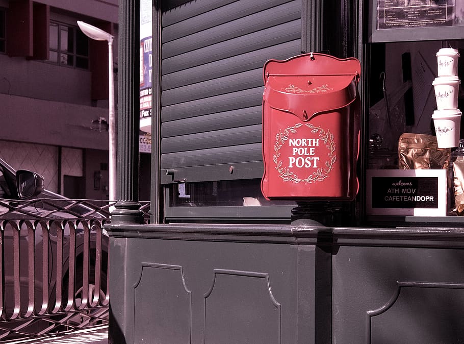 red North Pole post box near closed gray window, santa clau, puerto rico