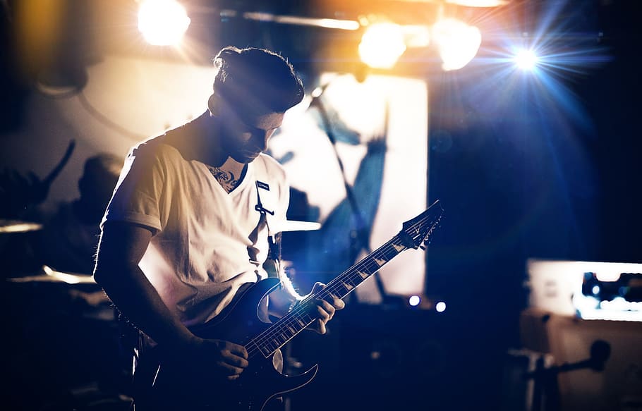 standing man playing electric guitar, stage, star, gig, pixpoetry