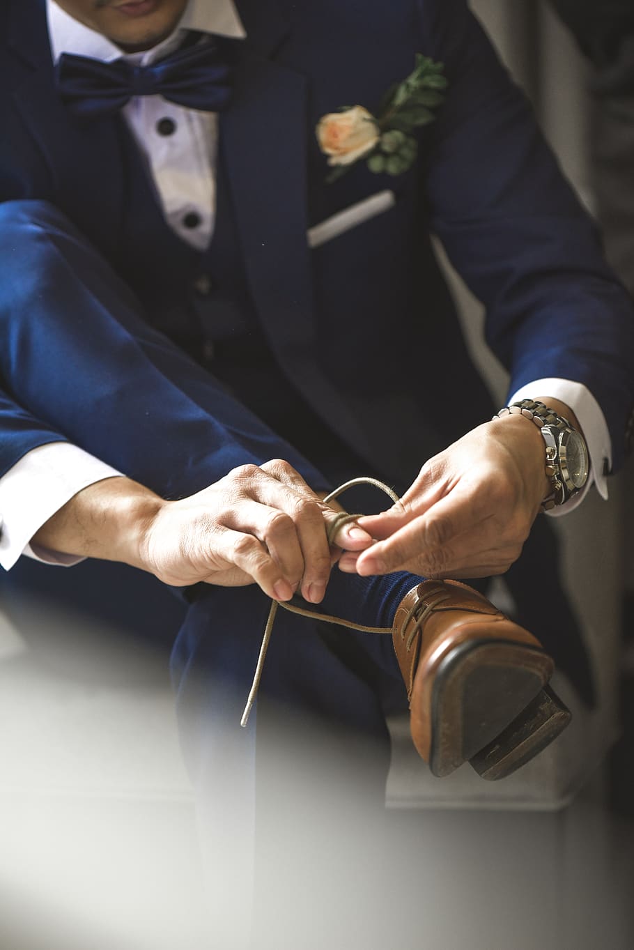 Person Tying Shoelaces, close-up, formal, groom, hands, indoors