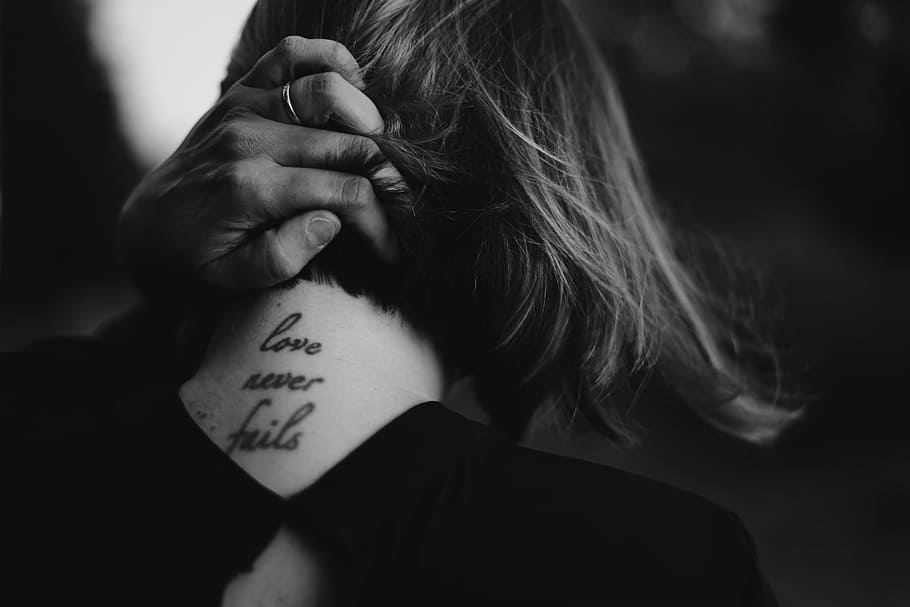 grayscale photo of woman holding her neck while showing Love never Fails tattoo at back, HD wallpaper