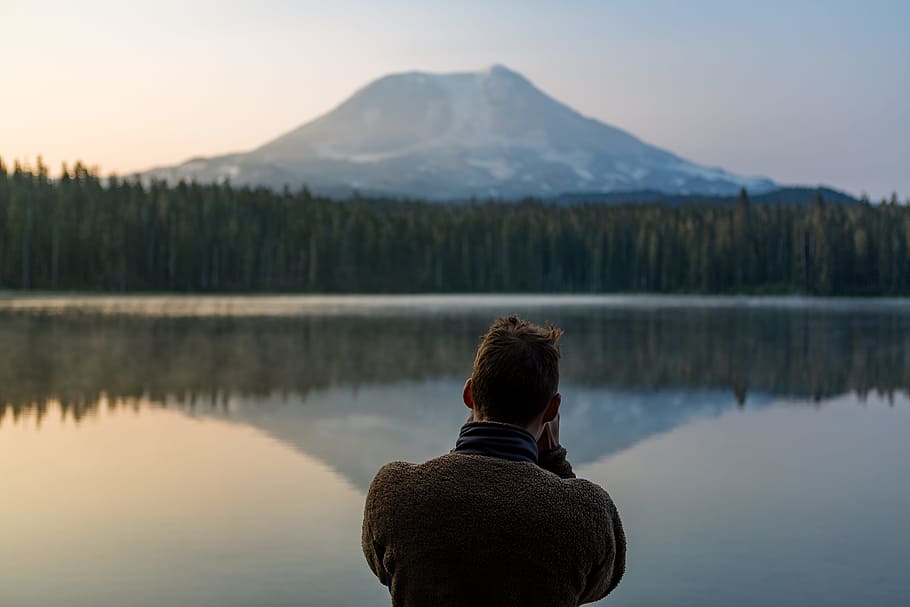 photo of person standing in front of water and forest, tree, woodland HD wallpaper
