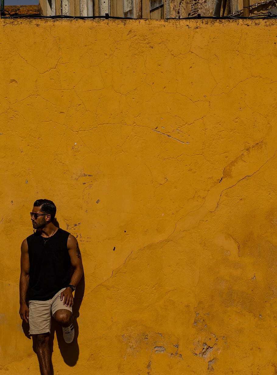 man leaning on yellow wall, architecture, wall - building feature HD wallpaper
