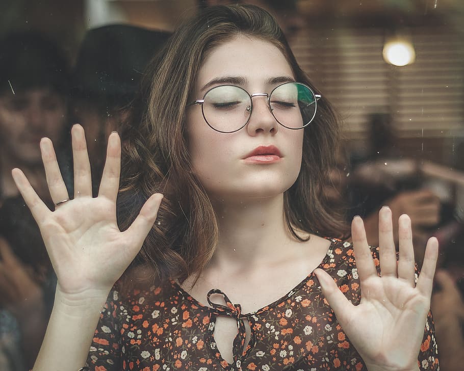 Woman Closing Her Eyes While Leaning On Clear Glass Wall, attractive HD wallpaper