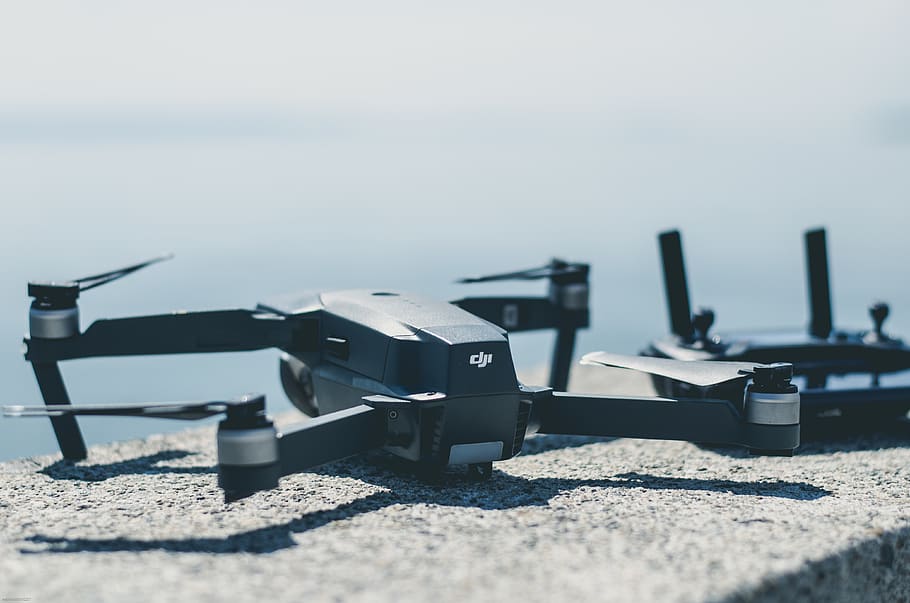 black DJI Mavi drone beside controller, selective focus, day HD wallpaper