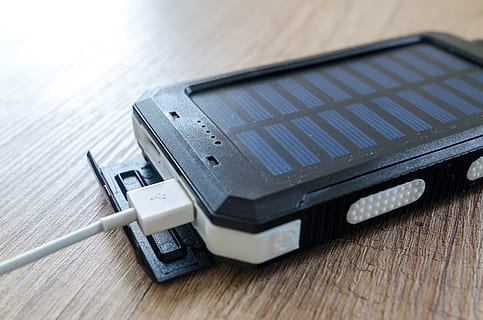 Black Solar Power Bank on Brown Surface, battery, charger, data HD wallpaper