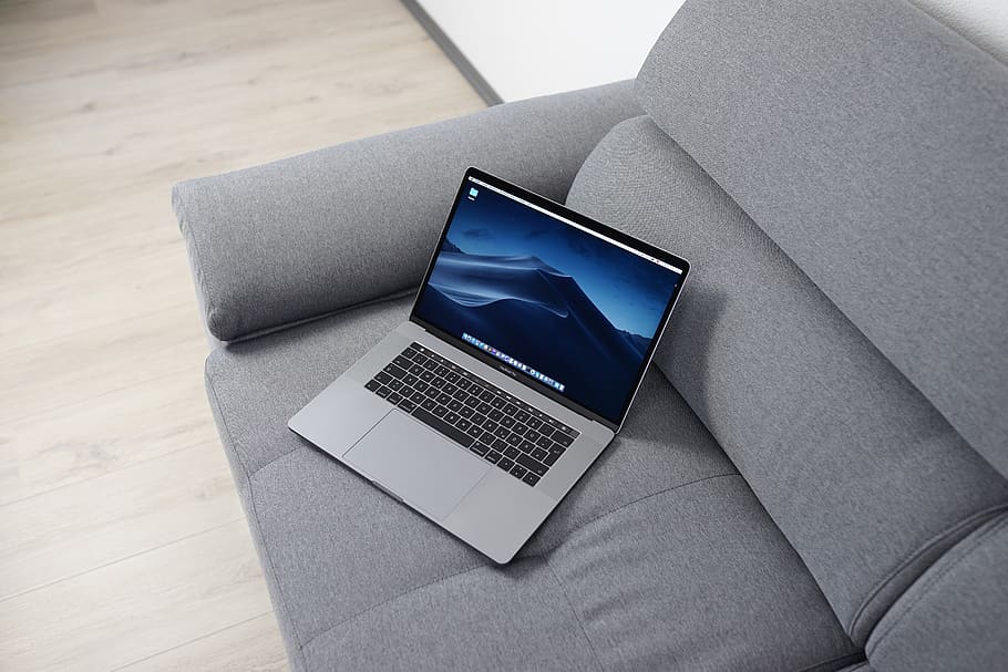 MacBook Pro on gray sofa, technology, computer, laptop, connection HD wallpaper