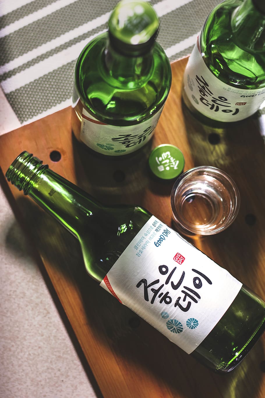 three Kanji script text bottles on wooden panel, table, high angle view HD wallpaper