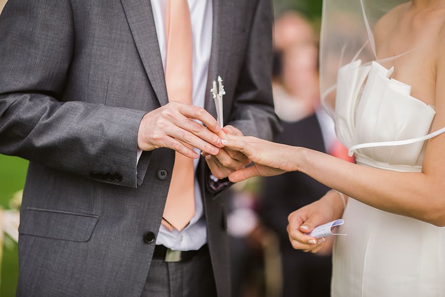 Photo of Groom Putting Wedding Ring on His Bride, adult, blur
