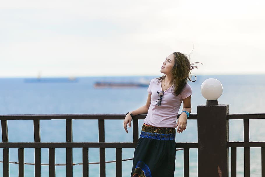 Woman Resting Beside Brown Steel Fence Looking at Sky, beach HD wallpaper