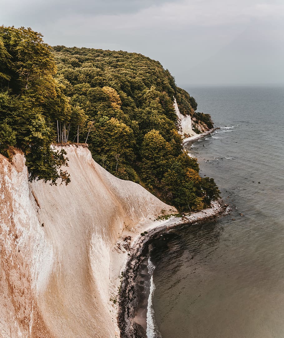 Photo of Island Near Body of Water, beach, cliff coast, clouds HD wallpaper