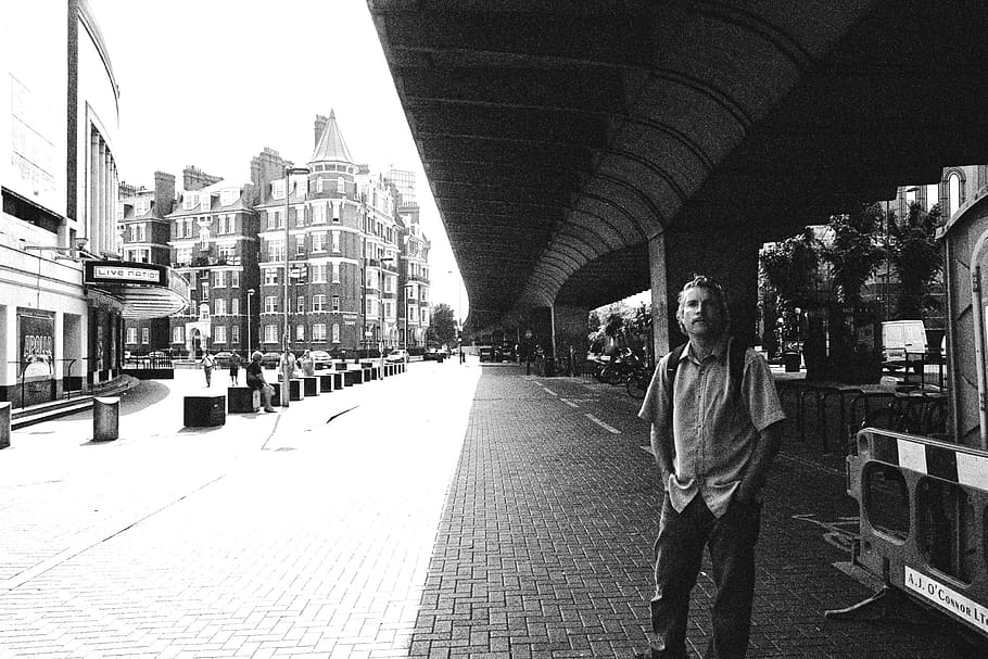 man standing on sidewalk, pedestrian, person, human, path, train station HD wallpaper