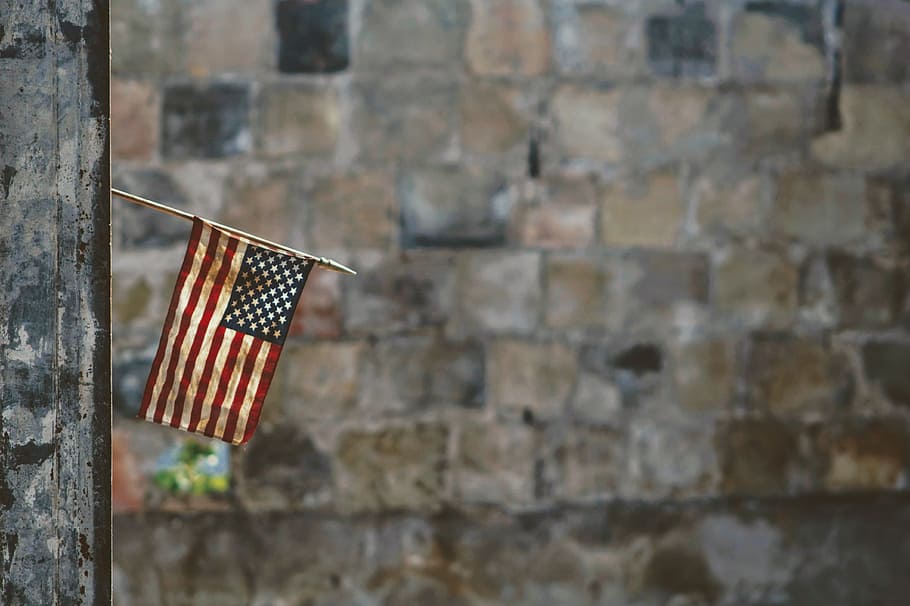 flag of America hanging on wall, post, old, vintage, worn, dirt