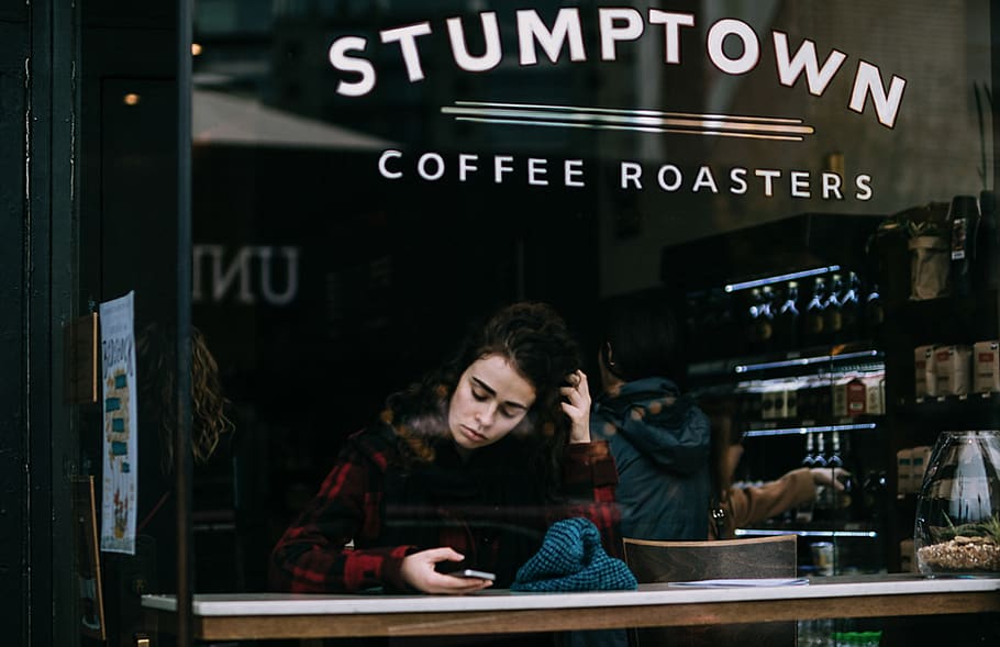 Woman Sitting Inside Stumptown Establishment, coffee, coffee shop