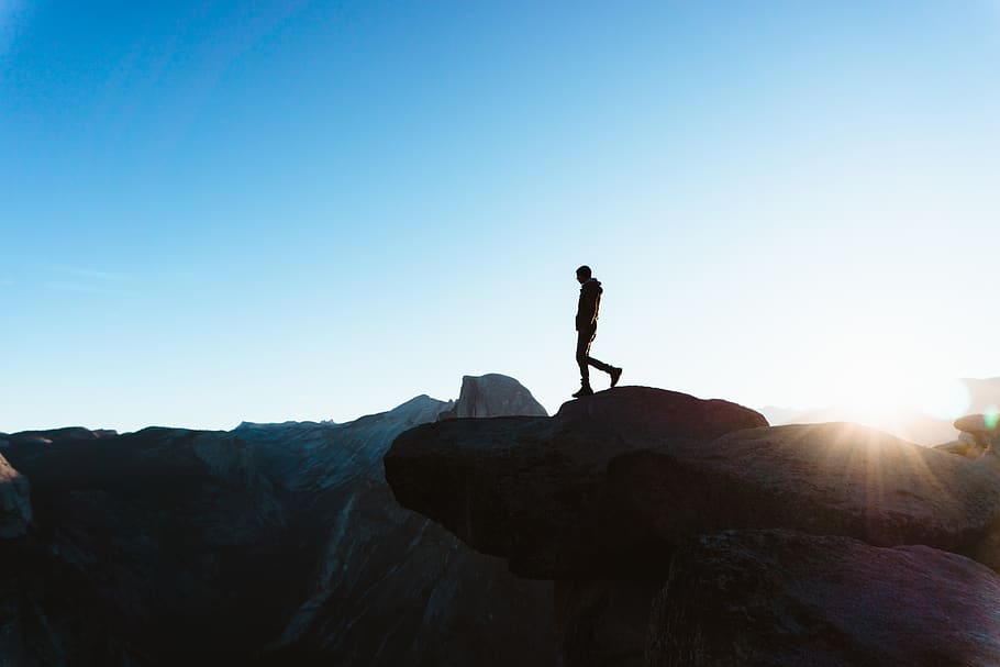 silhouette of man on peak, outdoors, nature, human, person, flare