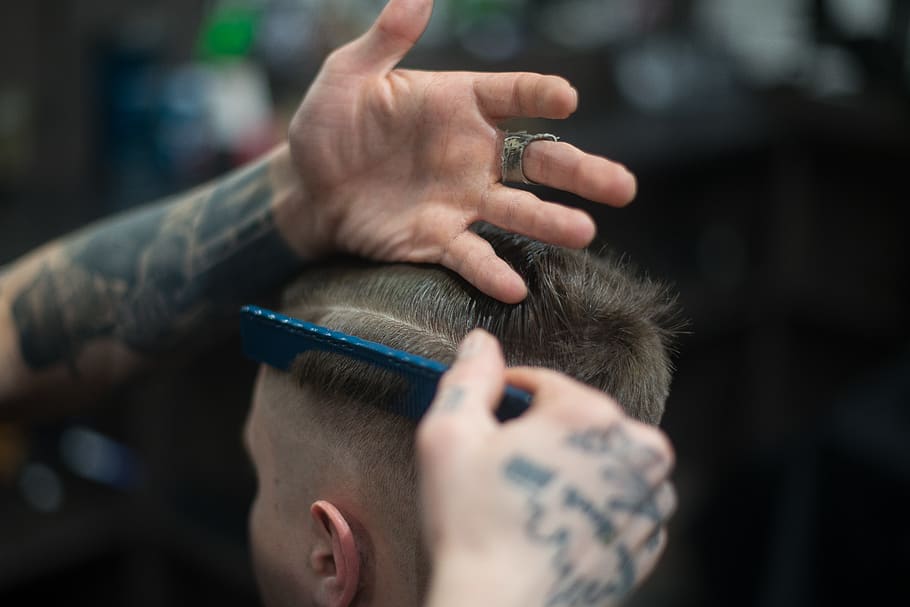Person Combing Person's Hair, barber, blurred background, close-up