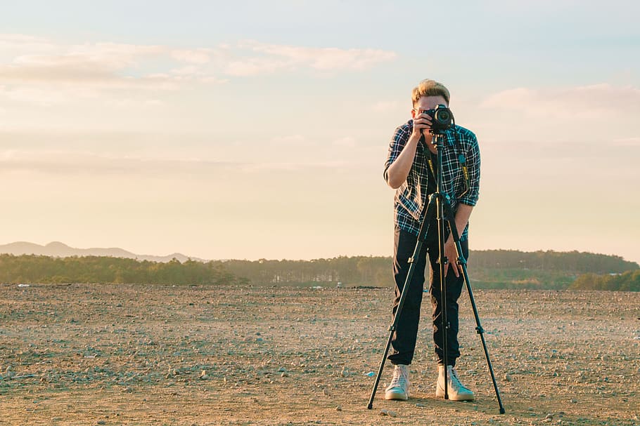 Man Wearing Sport Shirt While Holding Camera, clouds, daytime HD wallpaper