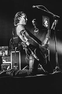 Man Kneeling While Playing Guitar, artist, band, black-and-white HD wallpaper