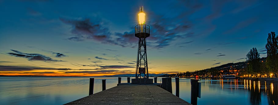 lighthouse on focus photography, water, sky, illuminated, nature HD wallpaper
