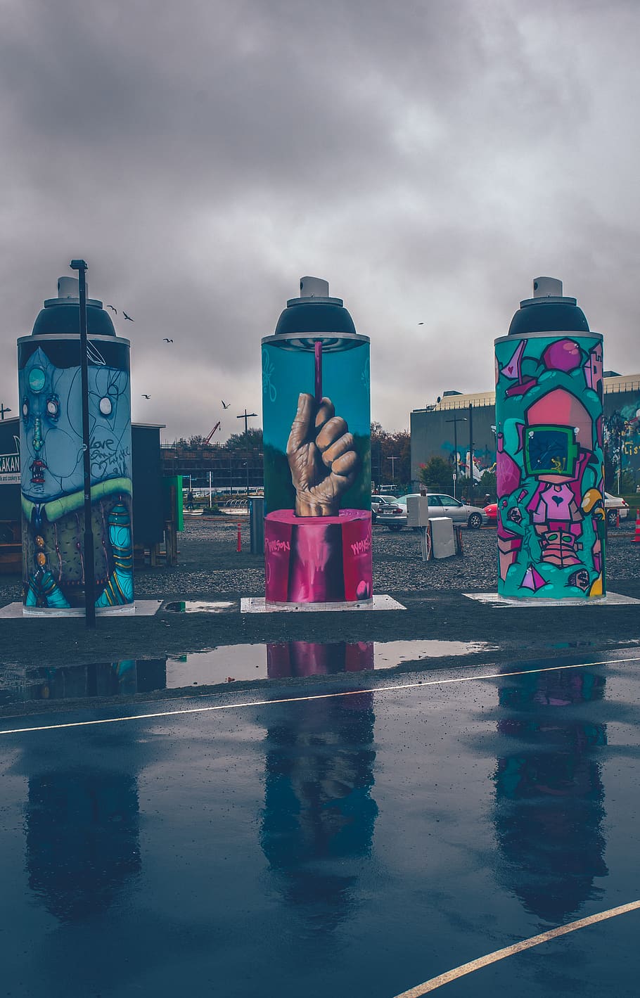 three-spray-bottle-themed-statues-beside-roadway.jpg