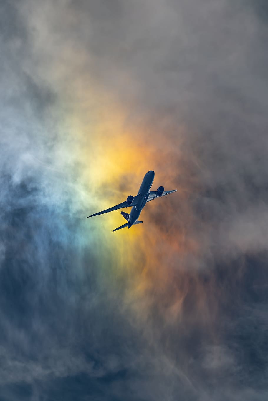 photo of white airplane under cloudy sky, aviation, flight, rainbow
