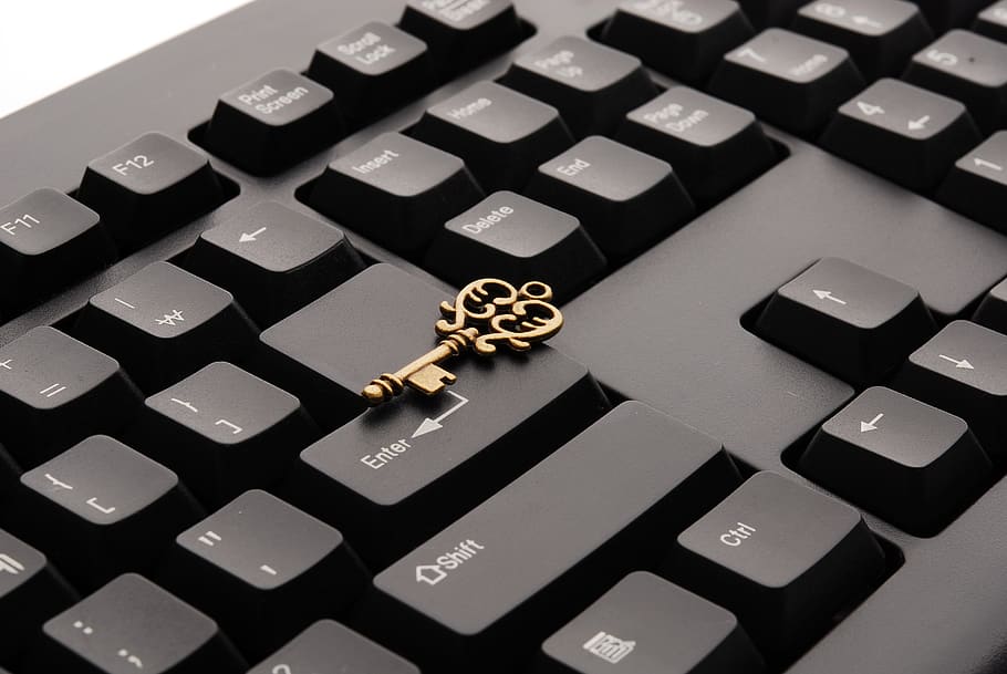 Brass Ornate Vintage Key on Black Computer Keyboard, close-up HD wallpaper