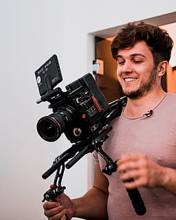 smiling man holding camera with stabilizers, person, human, electronics HD wallpaper
