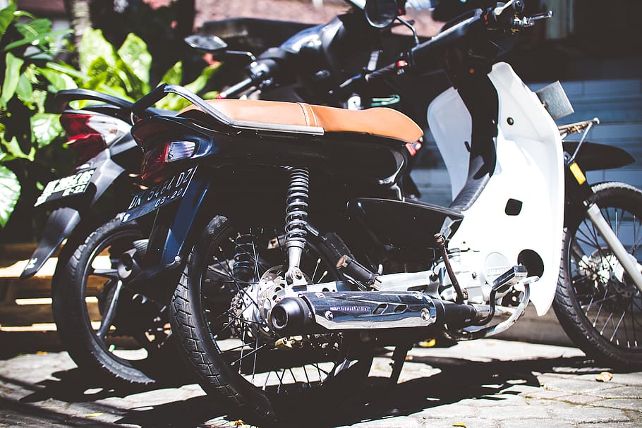 White Underbone Motorcycle Parked Beside a Motorcycle, black HD wallpaper