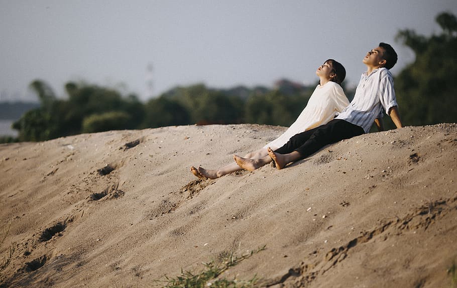 Man and Woman Sitting on the Sand, beach, boy, couple, daylight HD wallpaper