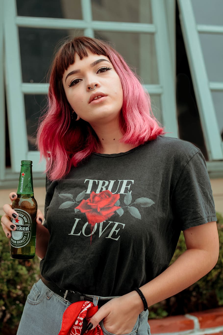 Woman Holding Heineken Beer Bottle Near Building, adult, alcoholic beverage