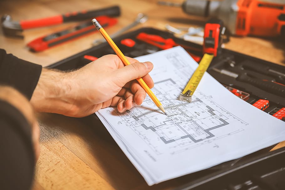 Worker make some notes in the technic plan of apartment, occupation HD wallpaper