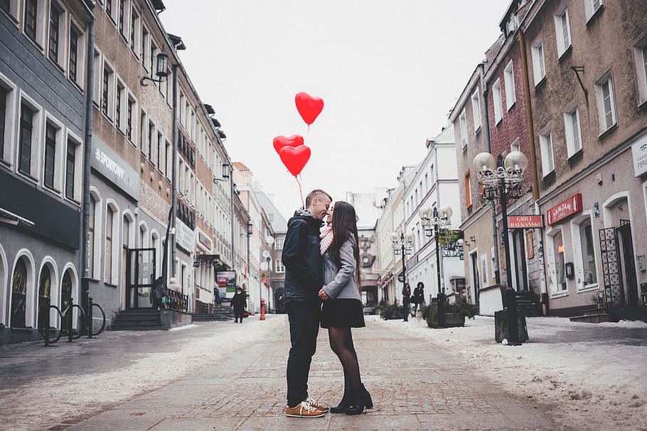 Couple Walking on City Street, architecture, balloons, buildings