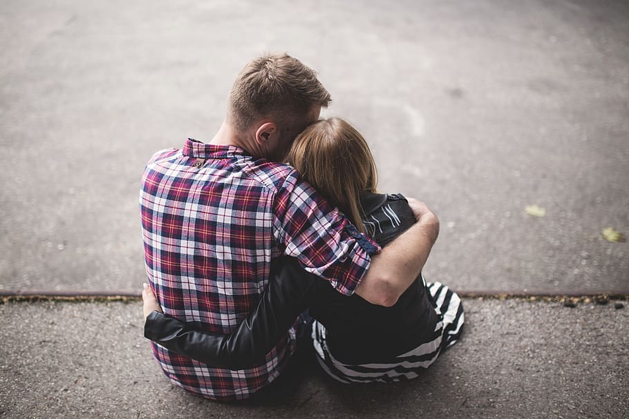 Man in Red White and Blue Check Long Sleeve Shirt Beside Woman in Black and White Stripes Shirt Hugging Each Other While Sitting on a Concrete Surface, HD wallpaper