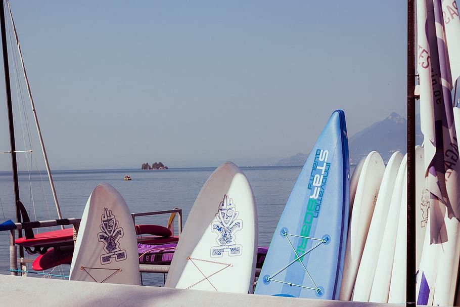 Surfboards Leaning on White Handrails, clear sky, daylight, ocean HD wallpaper