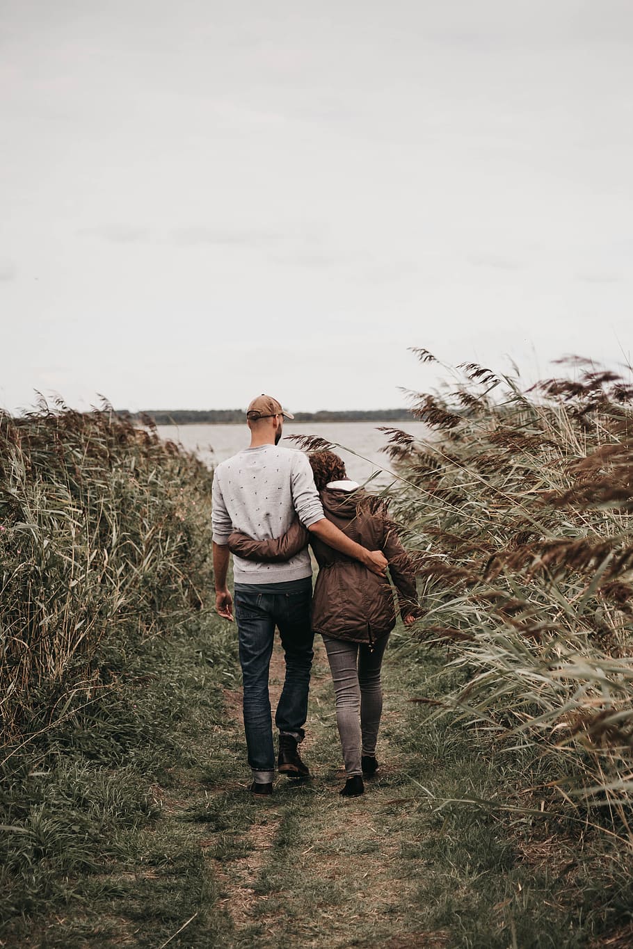 man hugging woman while walking, person, grass, human, people HD wallpaper