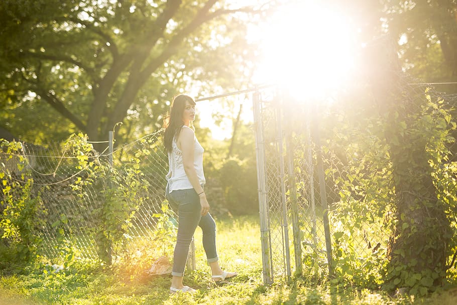 woman standing holding fence, light, flare, person, human, sunlight, HD wallpaper