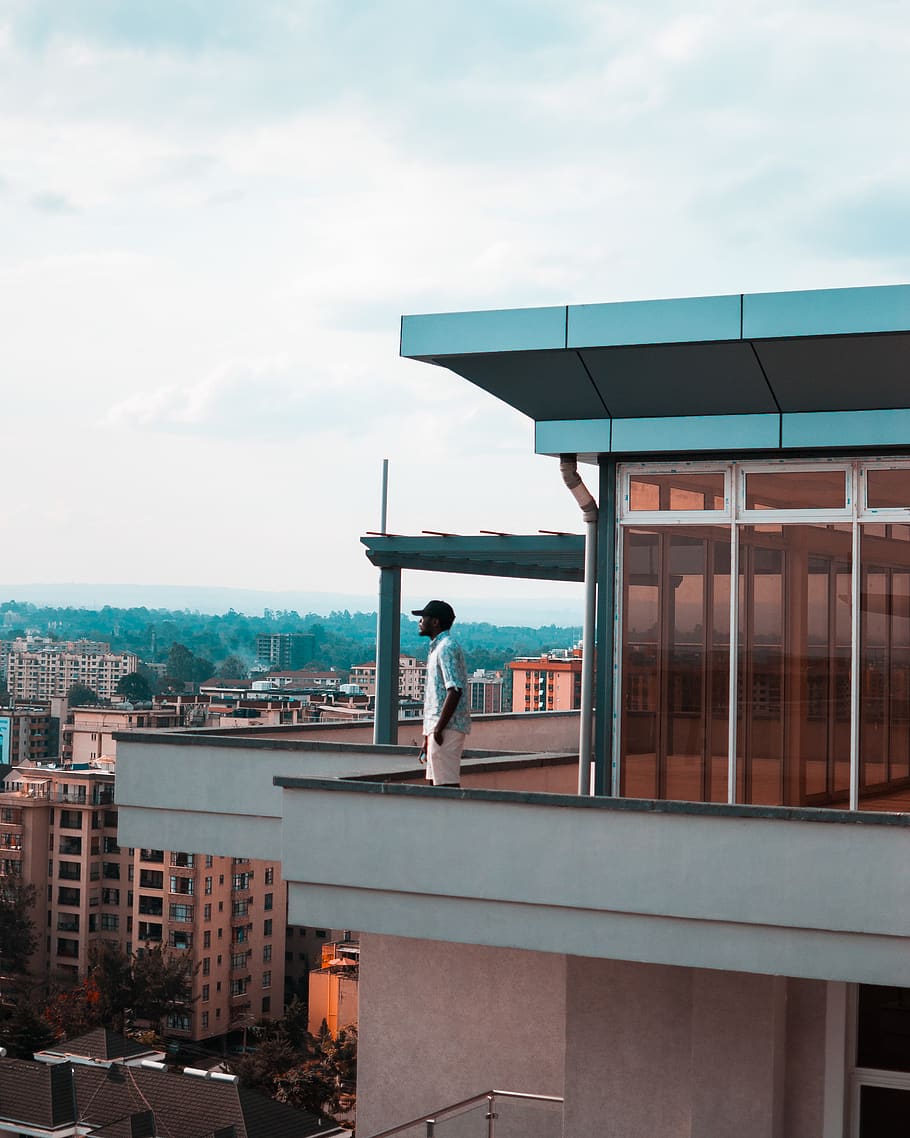 Man Standing on Balcony, architectural design, architecture, clouds HD wallpaper