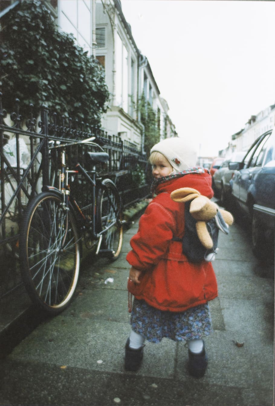 girl wearing red jacket near vehicles, wheel, machine, bike, bicycle