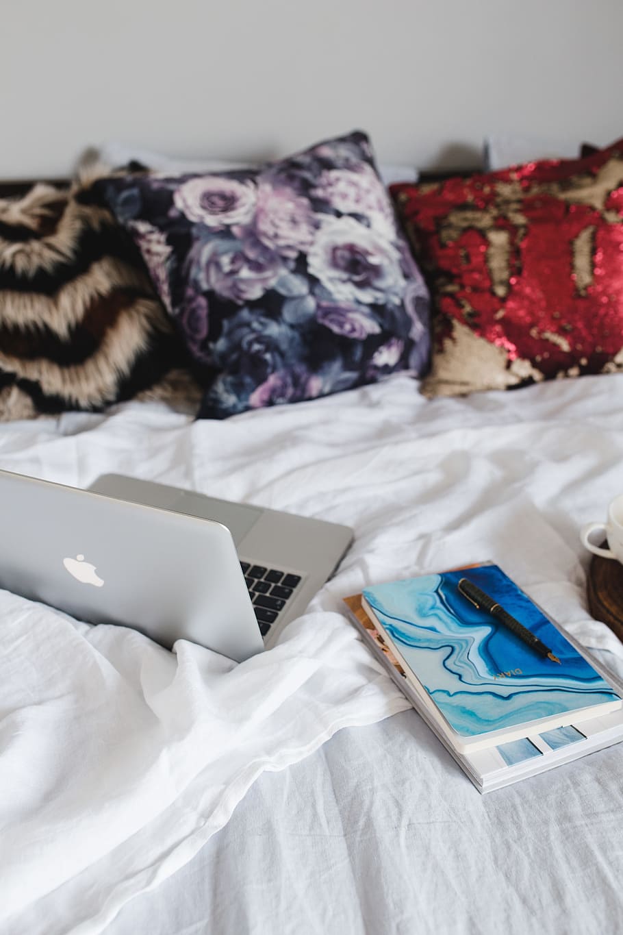 HD wallpaper: Bed full of pillows and notebooks with Apple gadgets ...